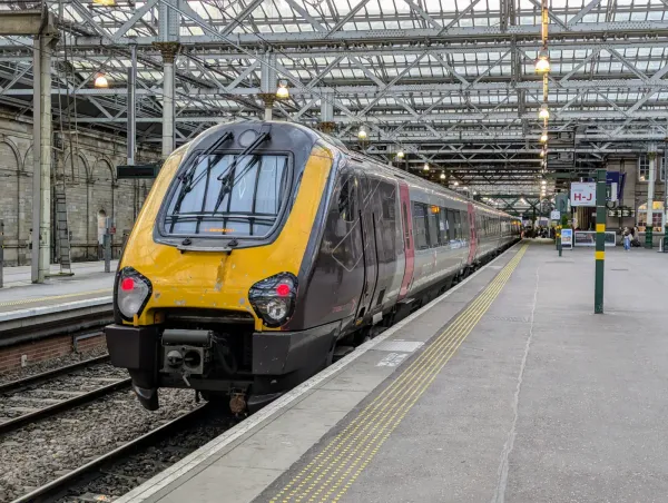 CrossCountry Class 221 Voyager train at Edinburgh Waverley Station, under the station's iconic glass and steel roof.