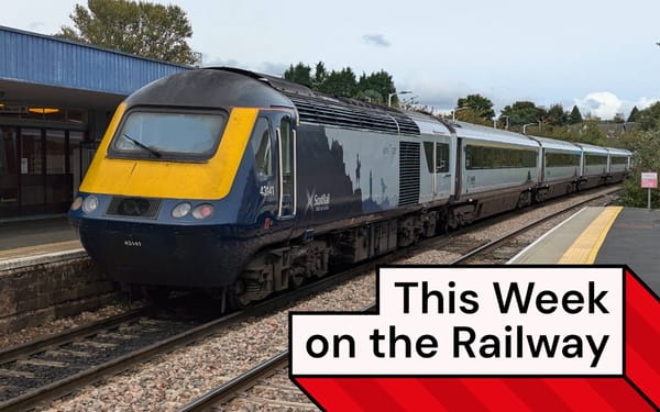 A ScotRail High Speed Train departs a station, its livery decorated with silhouettes of Scottish landmarks.